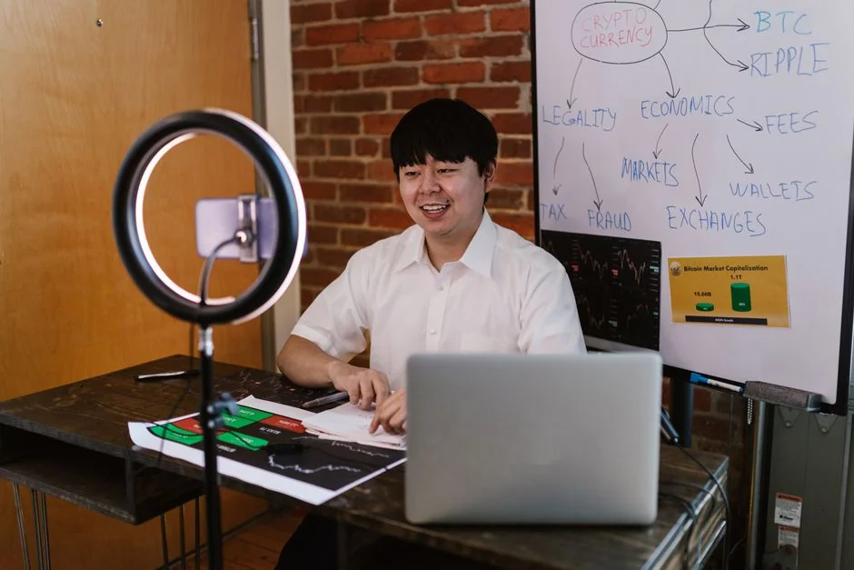 A modern workspace showing hands analyzing marketing data on a laptop and paper documents.
